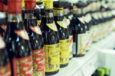 Bottles of balsamic vinegar on a grocery store shelf for Italian condiment selection