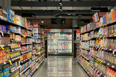 Supermarket aisle with stocked shelves for Italian food import planning